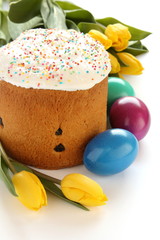 Easter bread, colorful eggs and yellow tulips