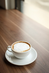 Coffee cup and book on the table