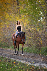 Young woman in medieval dress on horseback