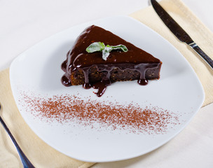 Freshly baked chocolate tart with sauce