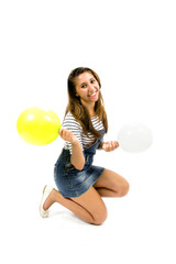 Smiling girl with sportswear and colorful balloons