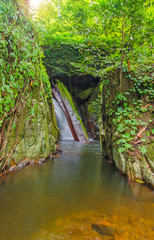 Fototapeta na wymiar Waterfall in deep rain forest jungle. Krok E Dok Waterfall Sarab