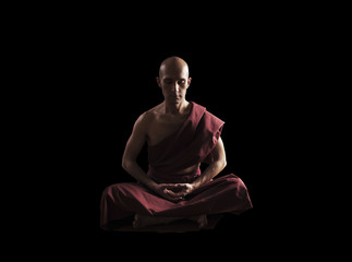 buddhist monk in meditation pose over black background - obrazy, fototapety, plakaty