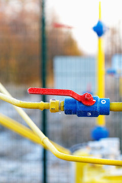 Yellow gas pipe with a crane and valve