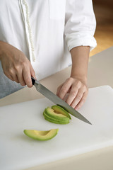 Hand slicing avocado