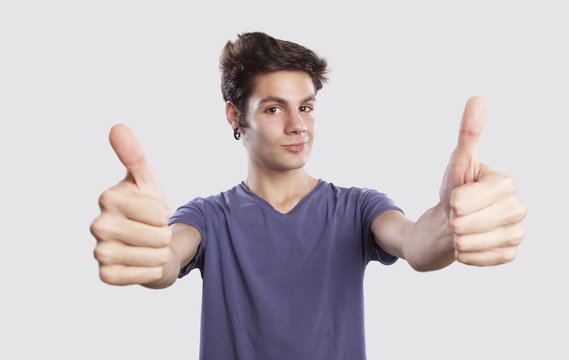 happy young man with thums up, funny face expression