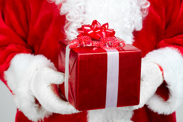 Hands of Santa Claus with gift