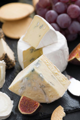 delicacy soft cheeses, fruit and crackers - snacks for wine