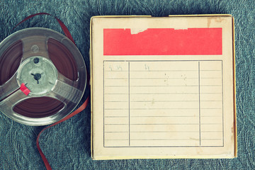 top view of old sound recording tape, reel to reel type and box