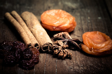 cinnamon, raisins, dried apricots on a wooden table.Shallow dept