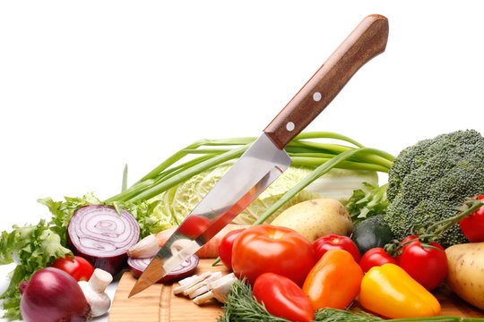 Fresh vegetables with knife on white background