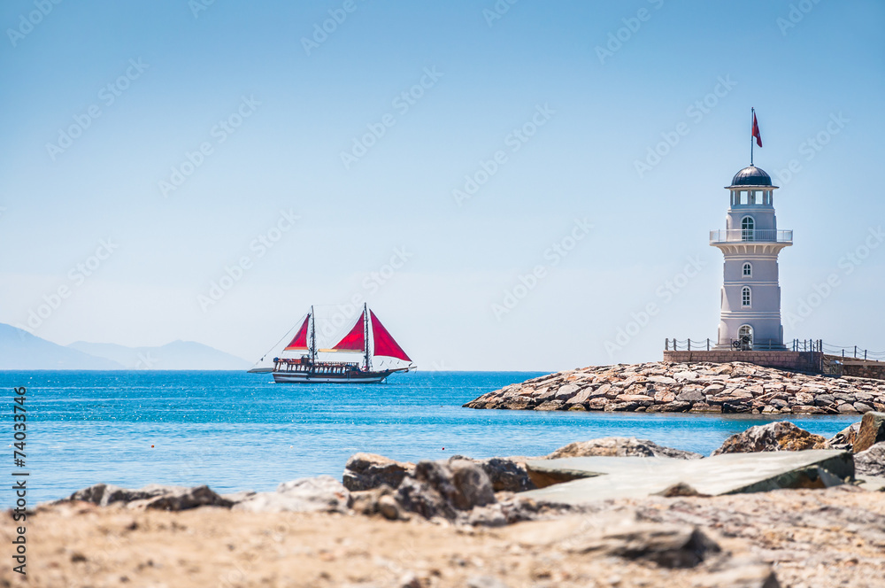 Wall mural lighthouse and tourist yacht by the sea