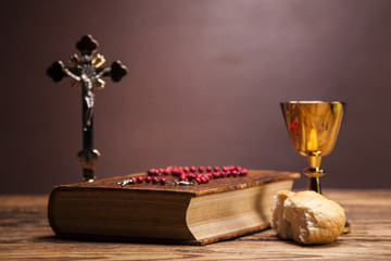 Sacred objects, bible, bread and wine.