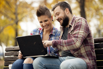 Young Urban People Outdoor Using Computer Laptop