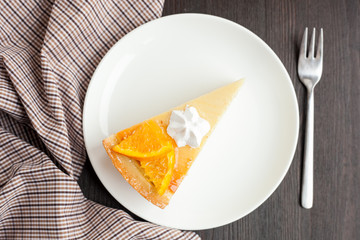 Cheesecake Dessert decorated with oranges and meringue