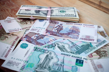 Fototapeta na wymiar stacks of hundred dollars and background ruble