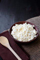 Delicious homemade cottage cheese on the wooden table