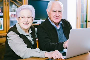 Senior couple working with Laptop at home - 74038994