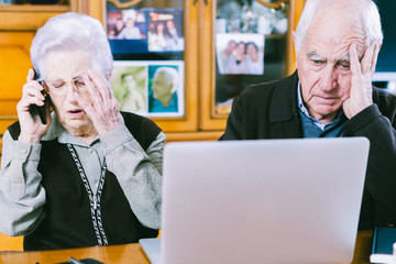 Senior couple working with Laptop at home