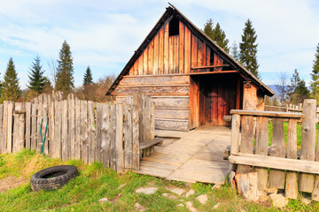 Shepherd wooden hut on meadow in autumn season