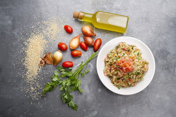 Delicious vegetarian quinoa salad with parsley, tomato and onion