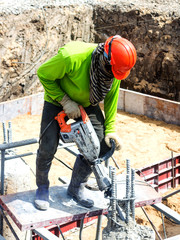 Portarait of positive Builder worker with pneumatic hammer drill