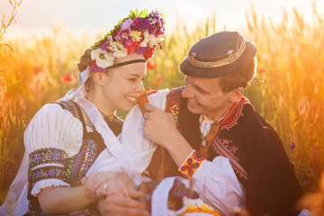 Couple in love with traditional folk costumes - obrazy, fototapety, plakaty