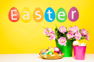 Colorful eggs, word Easter on yellow background