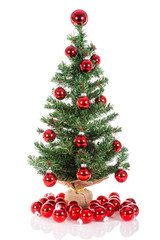 Christmas tree decorated with red balls isolated at white