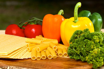 Uncooced lasagne pasta sheets on wooden table
