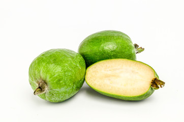 A feijoa and cut in half on a white background
