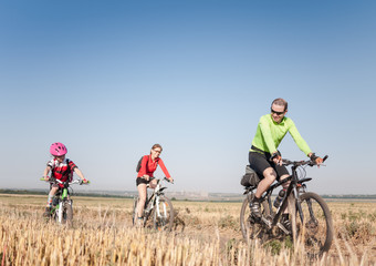 family cycling outdoors