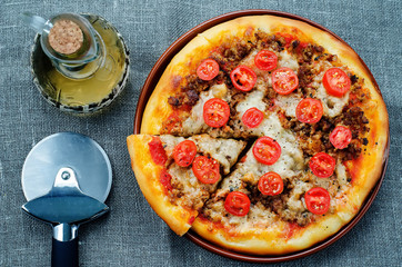 pizza with meat, mozzarella and tomatoes
