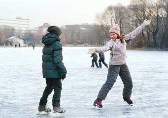 beautiful preteen girl figure skating in open winter skating rin