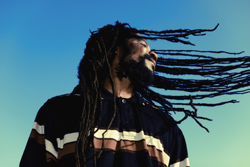 Happy man with “windy” dreadlocks. Caribbeans.