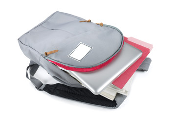 Backpack full of school supplies. on white background.