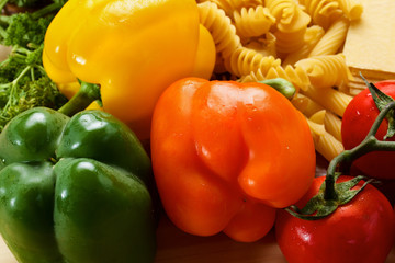 Fresh peppers and uncooced italian pasta with tomatos