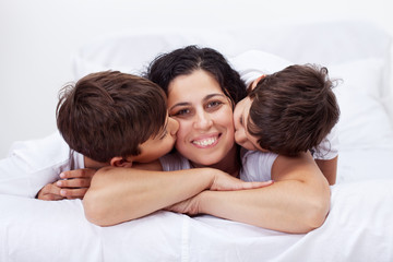 Obraz na płótnie Canvas Happy mother and her loving little boys