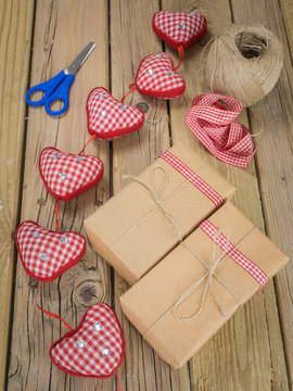 parcels wrapped in brown paper and string with ribbon and scisso