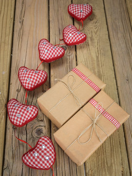 parcels wrapped in brown paper and string with red check hearts