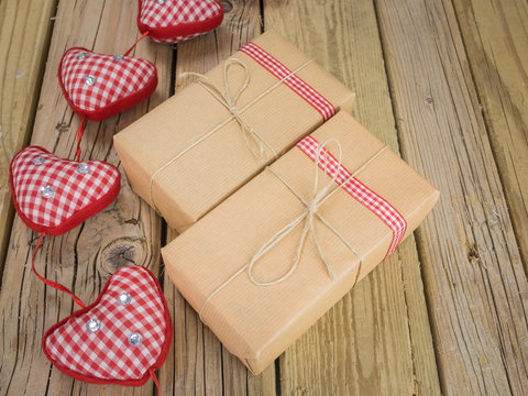 parcels wrapped in brown paper and string with red check ribbon