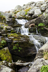 Fototapeta na wymiar Fresh water stream flowing down mountain