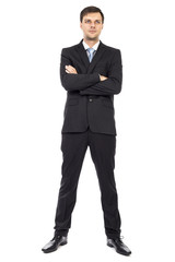 Full body portrait of  young business man with arms folded