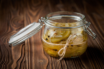 Natural diy marinated green tomatoes in a jar