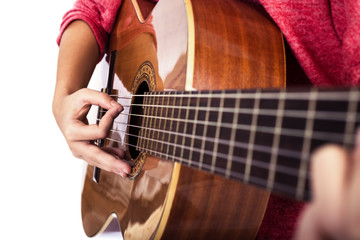 Closeup of girl´s hands playing acoustic quitar