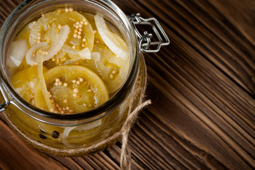 Natural diy marinated green tomatoes in a jar