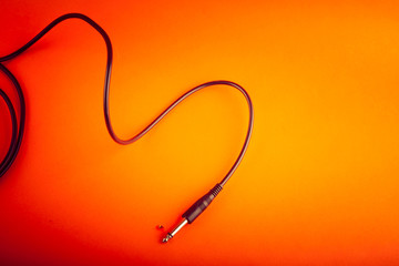 Abstract  flexible audio cable on orange, nice music background