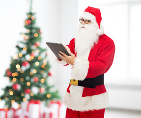 man in costume of santa claus with tablet pc