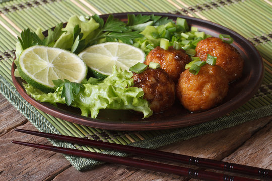 fish balls in curry sauce with lime and fresh herbs horizontal