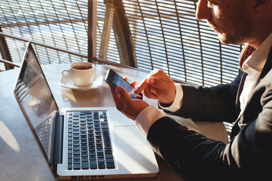 businessman using smartphone and laptop